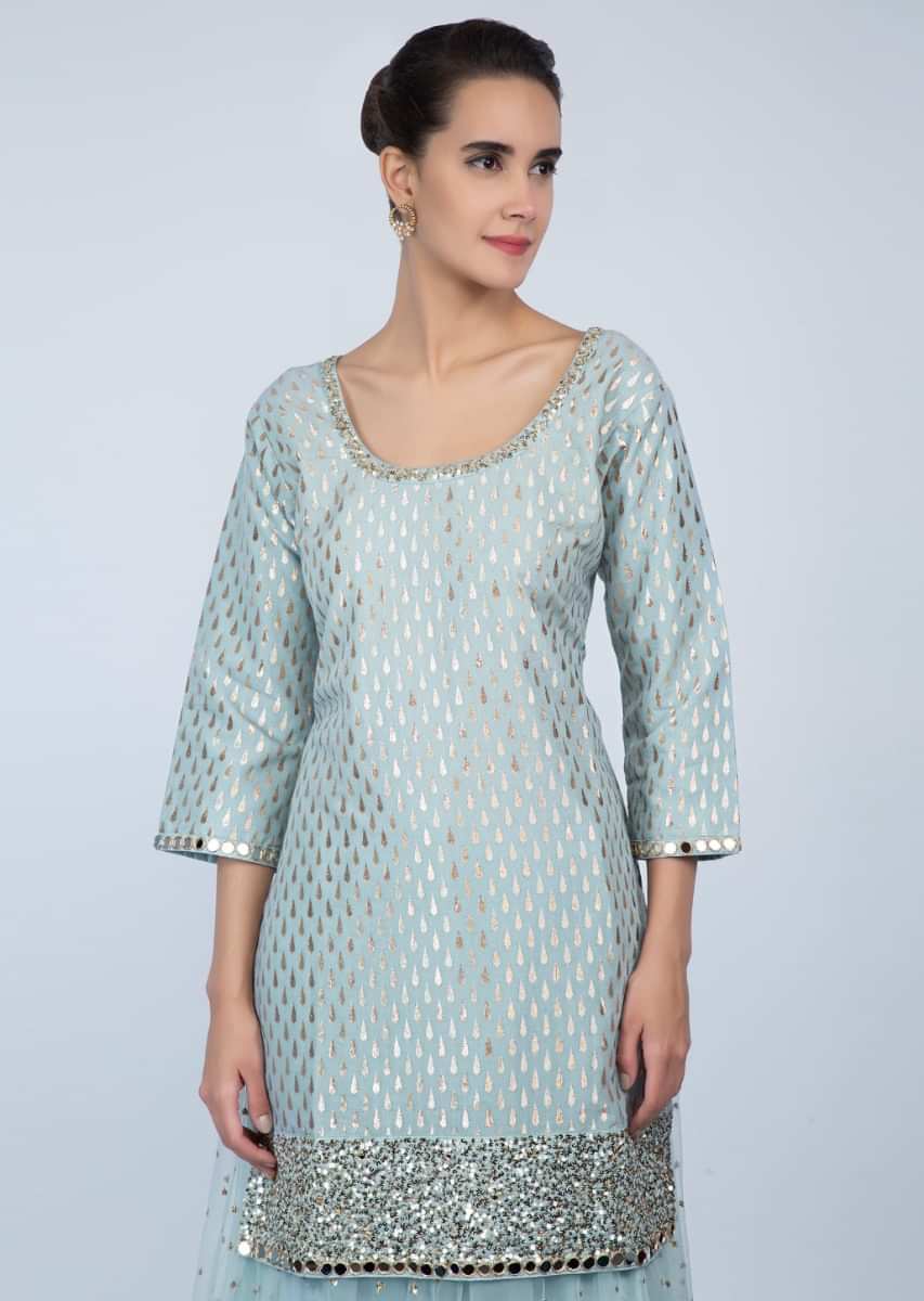 Powder blue long weaved top with matching flared net skirt only on Kalki