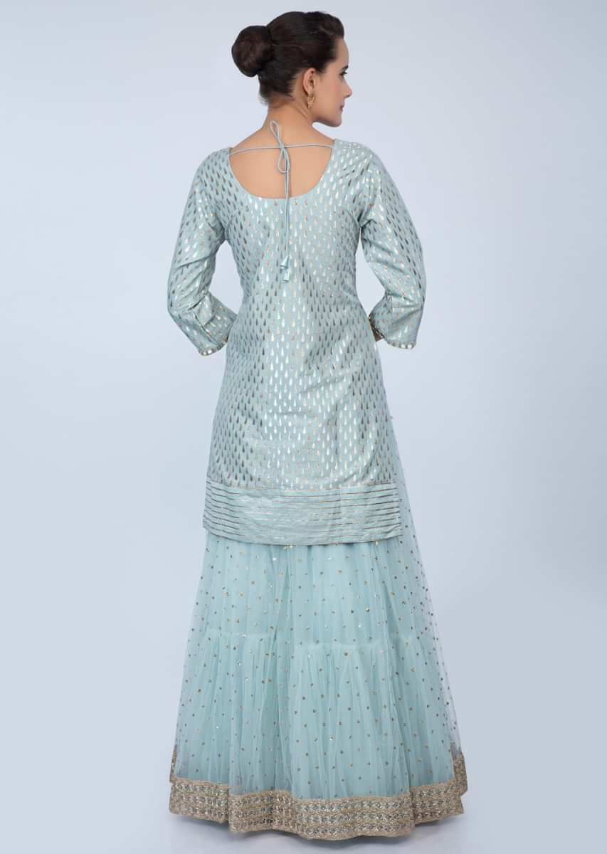 Powder blue long weaved top with matching flared net skirt only on Kalki