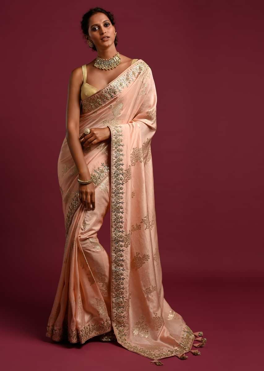Powder Peach Banarasi Saree With Weaved Floral Motifs And Embroidered Border  