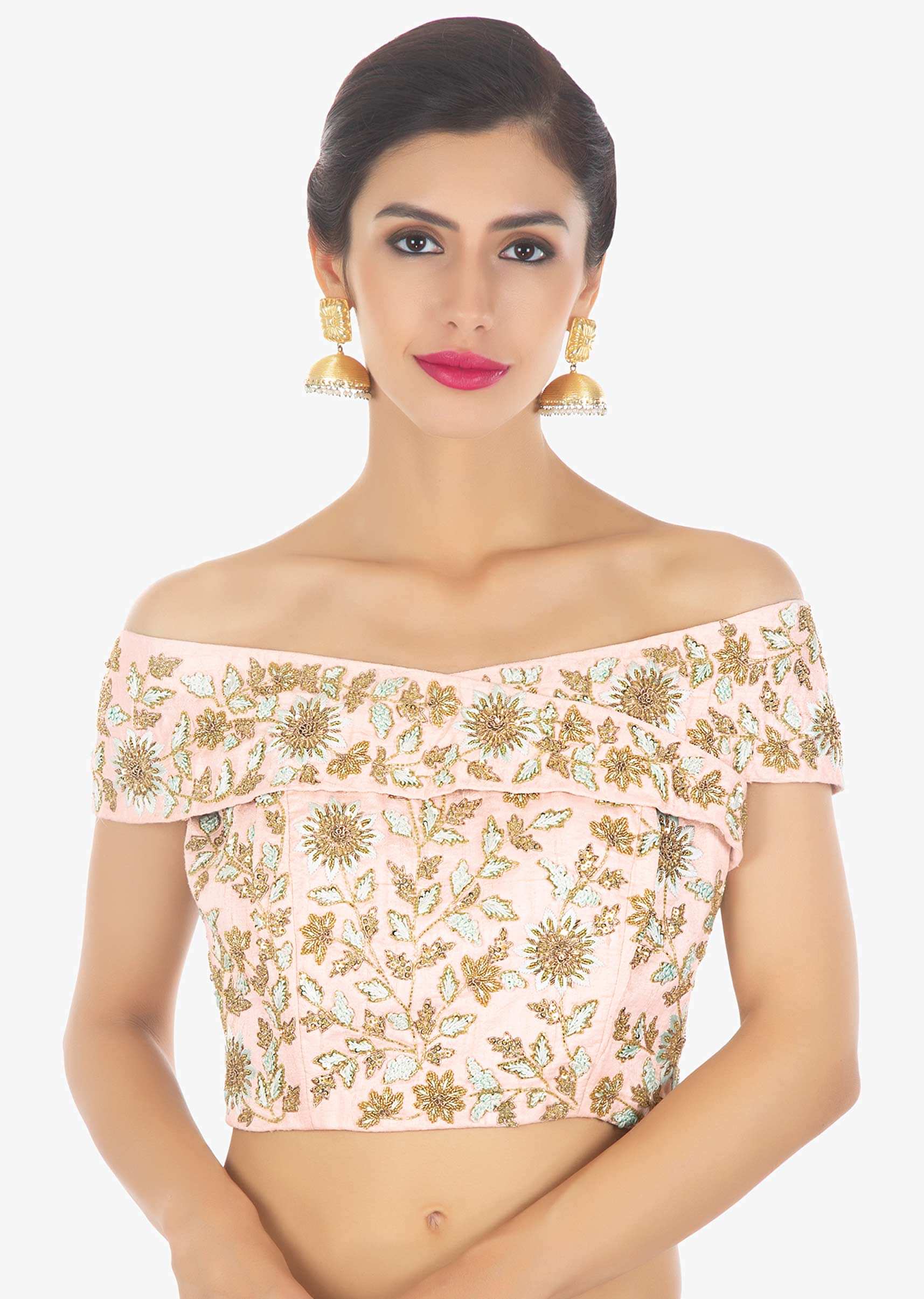 Powder pink heavily embellished net saree paired with matching raw silk off shoulder blouse