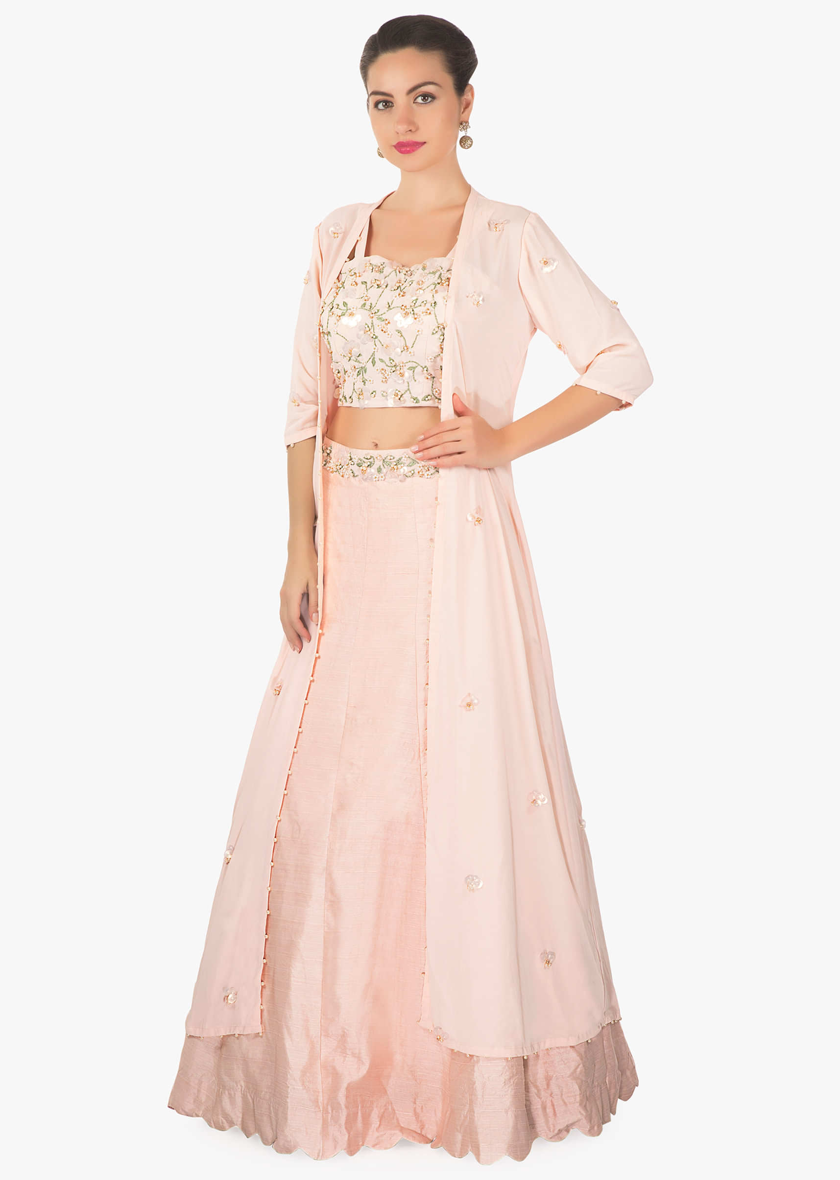 Powder pink lehenga matched with crop top blouse and long embroidered jacket