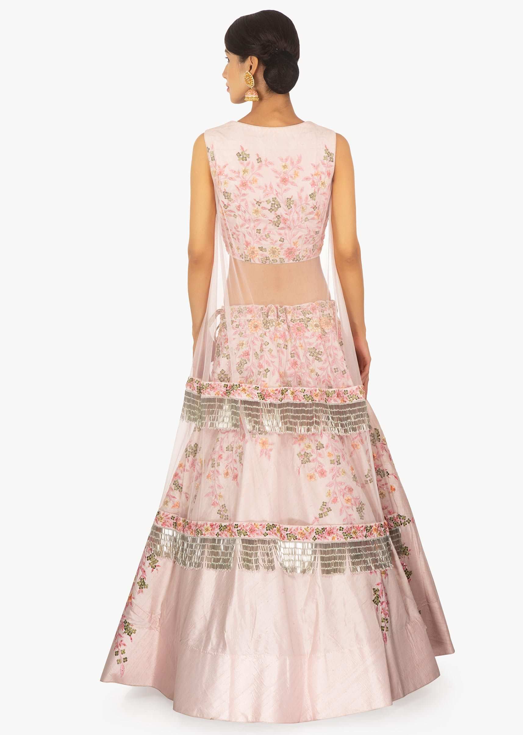 Powder pink lehenga paired with a matching blouse with a preattached net jacket