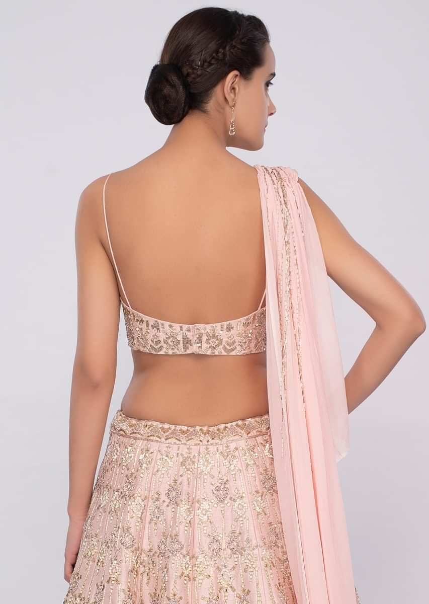 Powder Pink Lehenga In Raw Silk Teamed With One Side Strap Bustier With Georgette Drape Online - Kalki Fashion