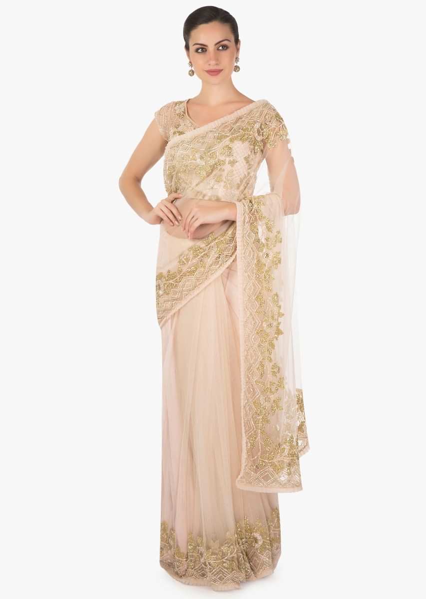 Powder pink net saree featuring in cutdana embroidery