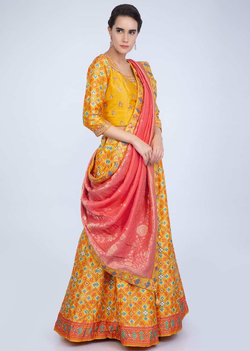 Pine Yellow Lehenga With Patola Print And Contrasting Punch Pink Weaved Dupatta Online - Kalki Fashion