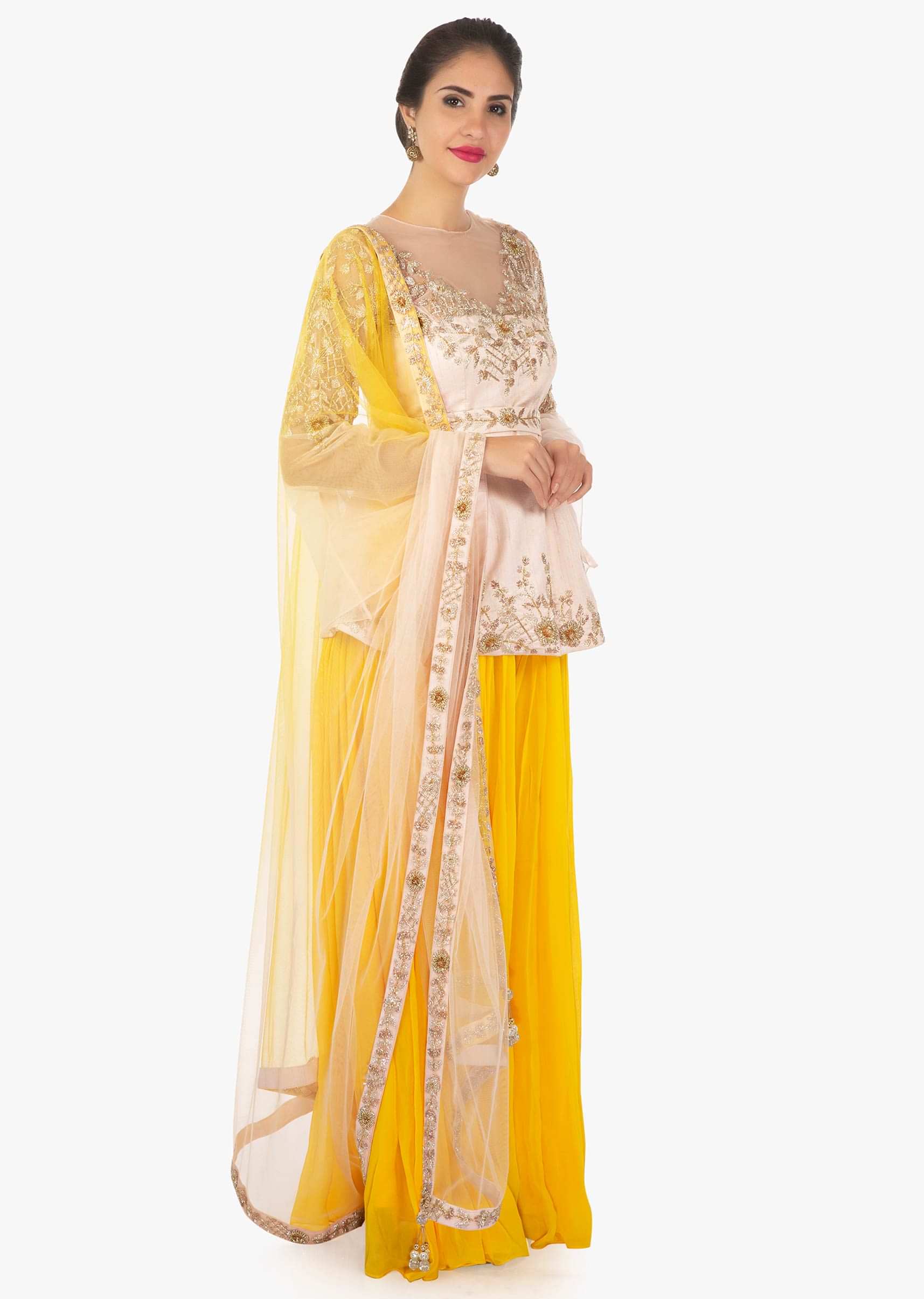 Raw silk yellow pleated palazzo paired with a powder pink long blouse only on Kalki
