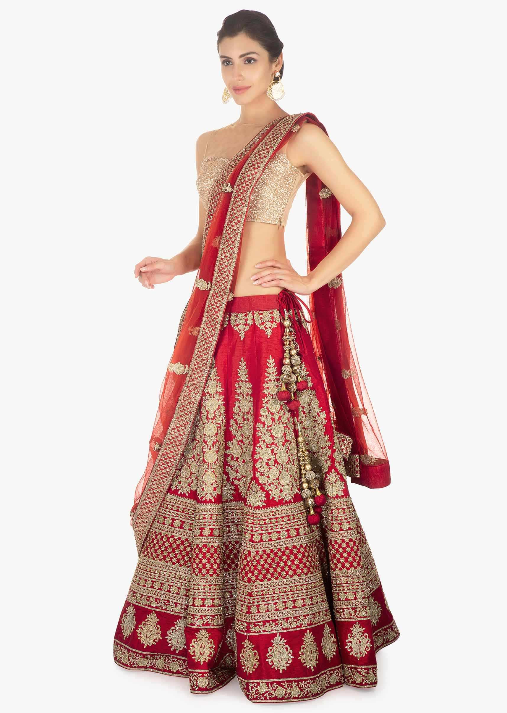 Red raw silk  lehenga set paired with net dupatta embellished in floral embroidery