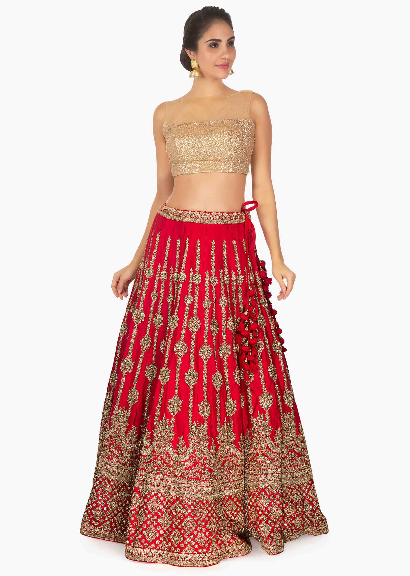 Red raw silk lehenga in sequins and zari along with a matching  net dupatta 