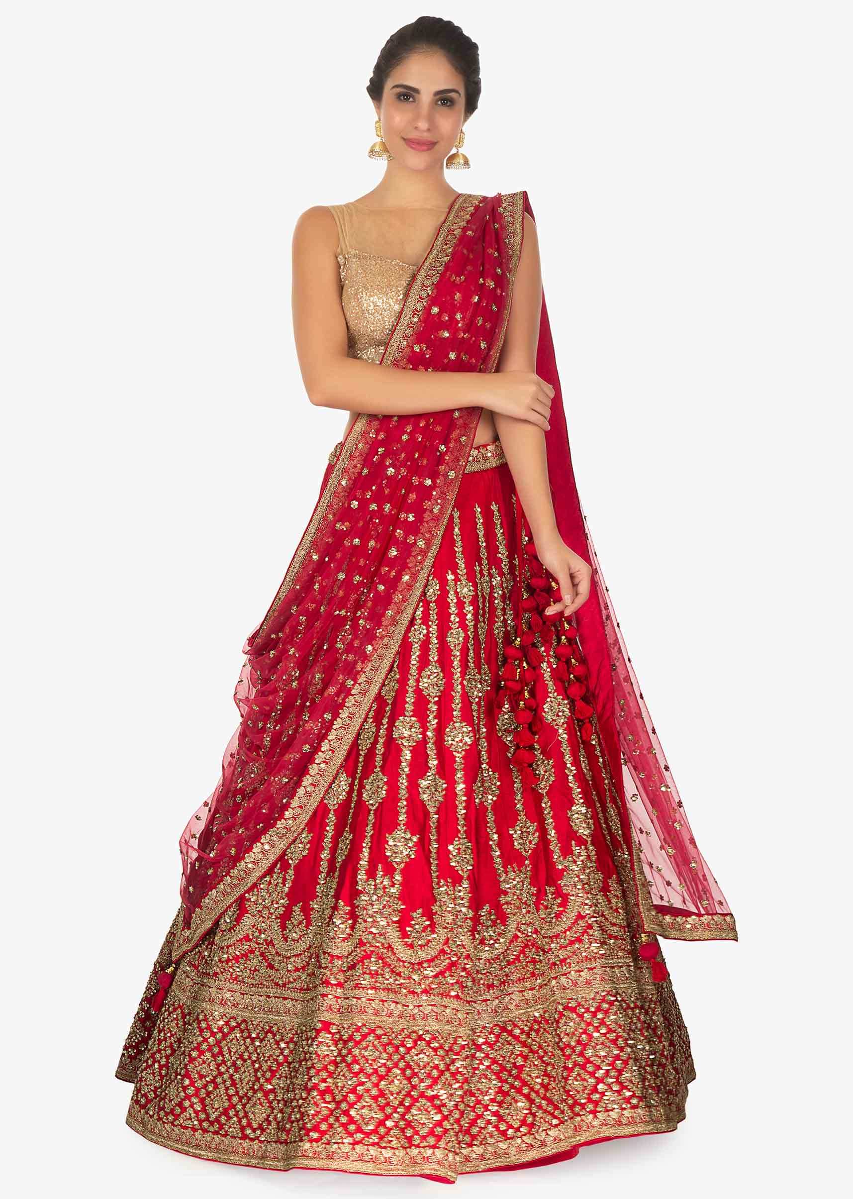 Red raw silk lehenga in sequins and zari along with a matching  net dupatta 