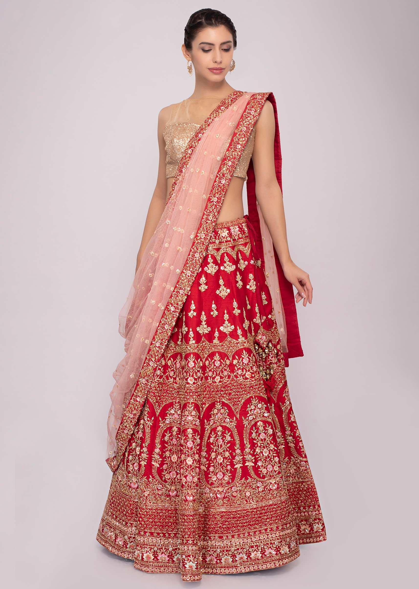 Red raw silk lehenga with pink net dupatta and unstitched red blouse