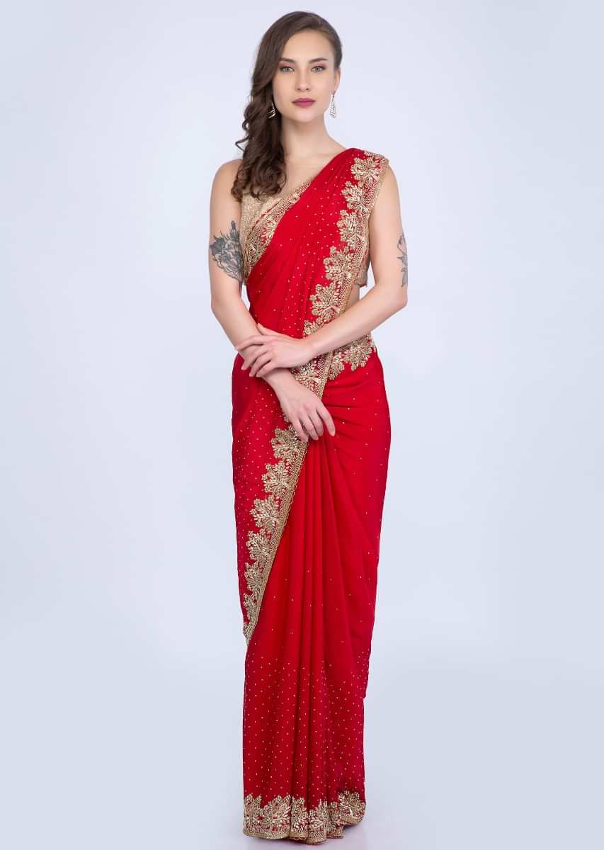 Red satin chiffon saree with heavy golden embroidered border only on Kalki