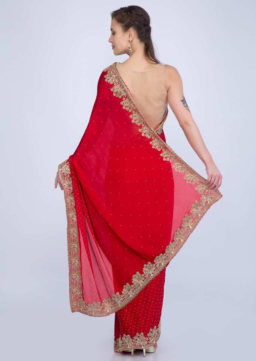 Red satin chiffon saree with heavy golden embroidered border only on Kalki