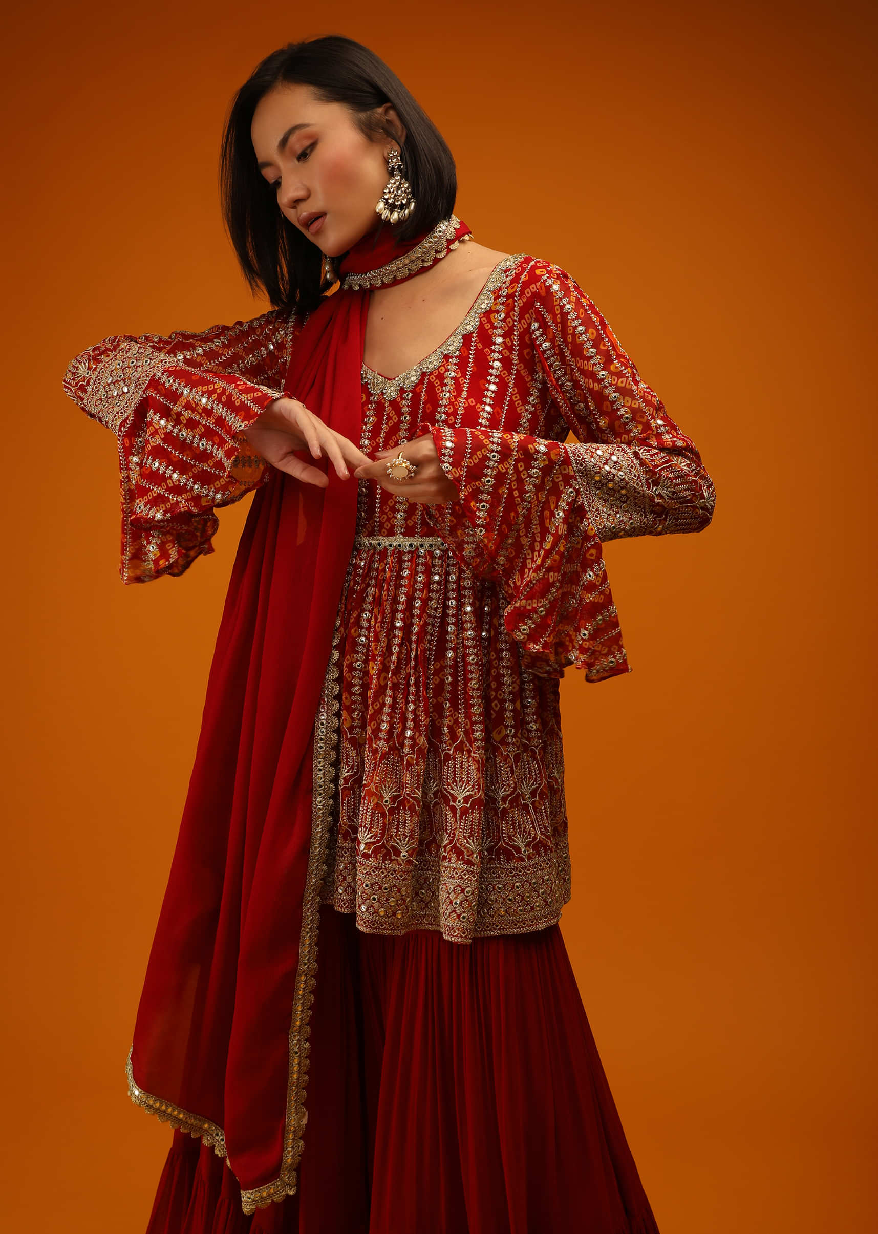 Red Sharara And Peplum Suit In Georgette With Bandhani Design, Mirror Work And Bell Sleeves