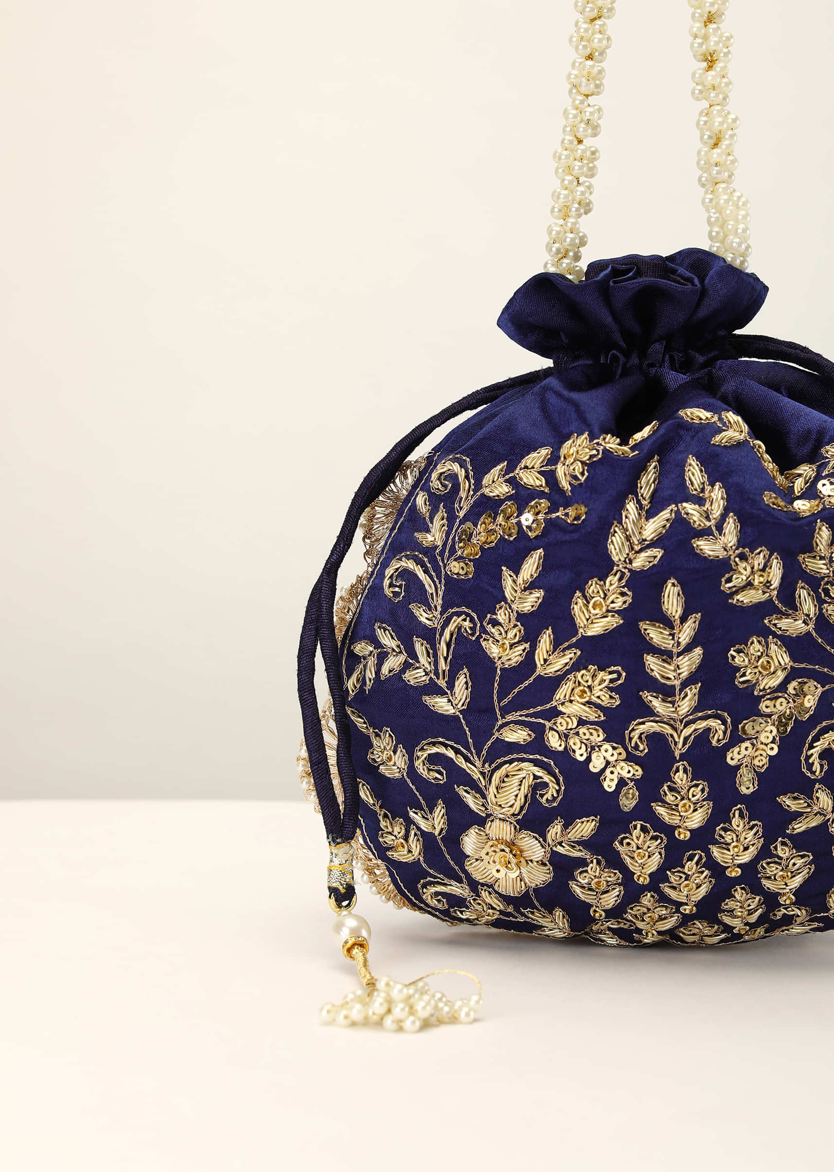 Royal Blue Potli In Satin With Hand Embroidery Detailing Using Zardosi Work In Floral Design All Over