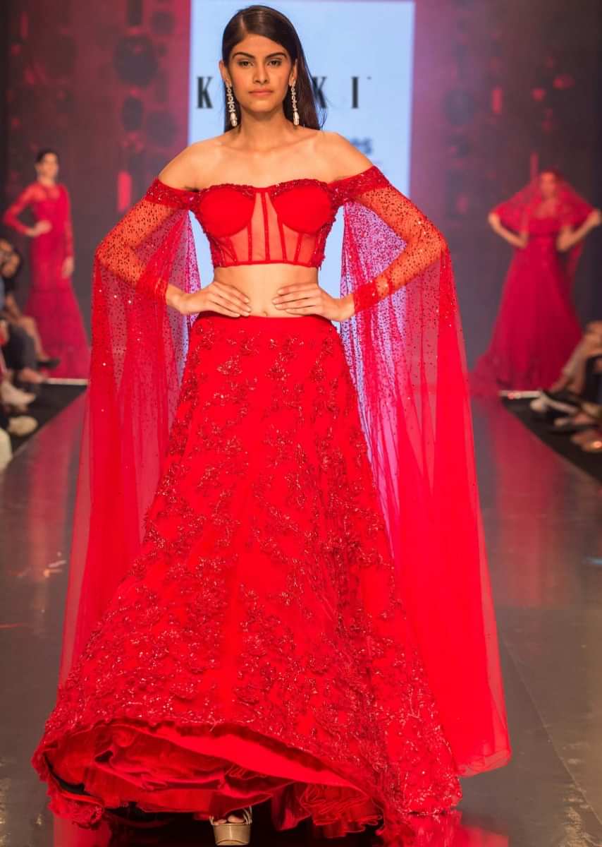 Ruby Red Lehenga In Heavily Embroidered Net With Fancy Off Shoulder Blouse With Long Fared Sleeves 