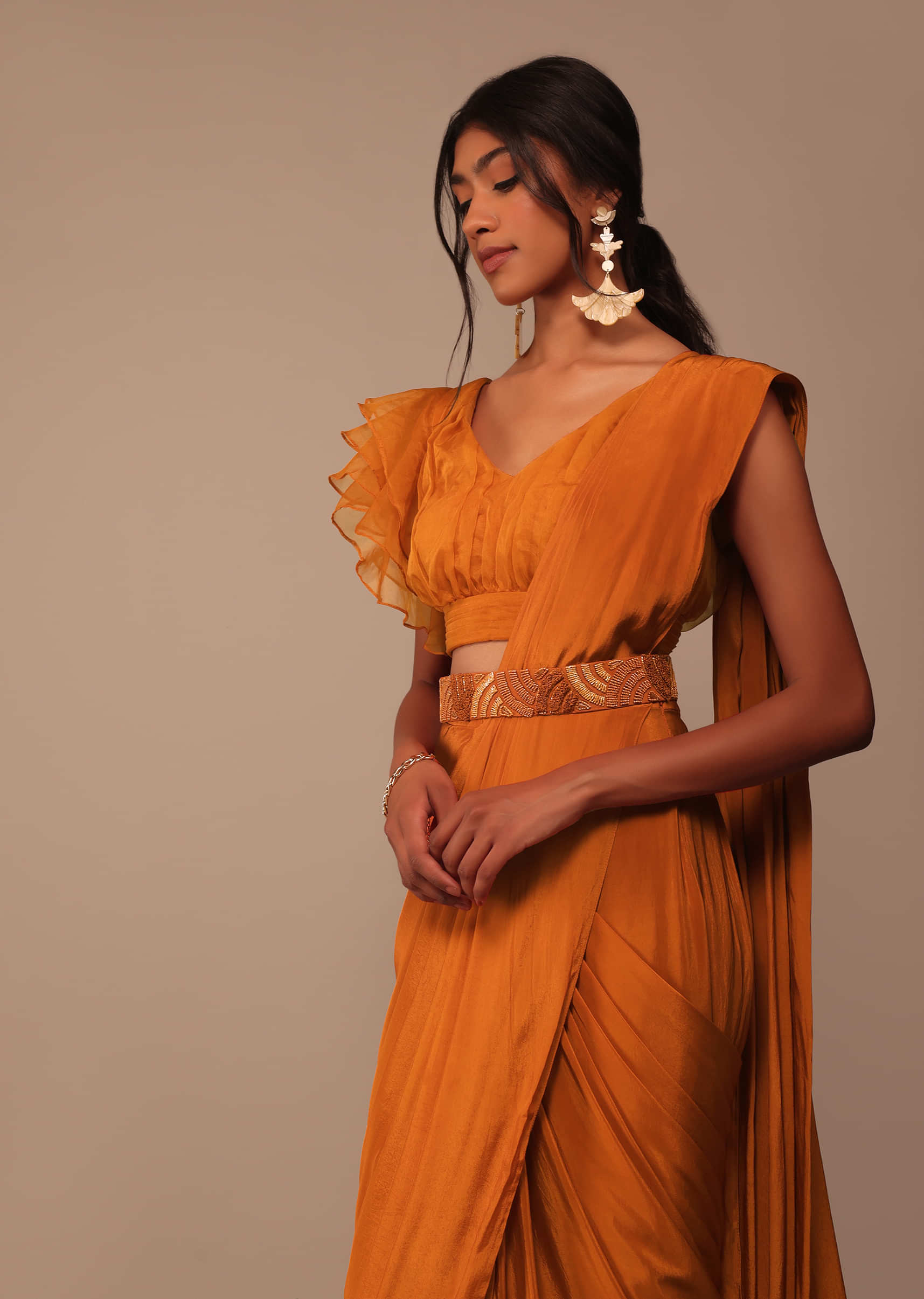 Rust Orange Saree With Fancy Ruffle Blouse And Embroidered Belt