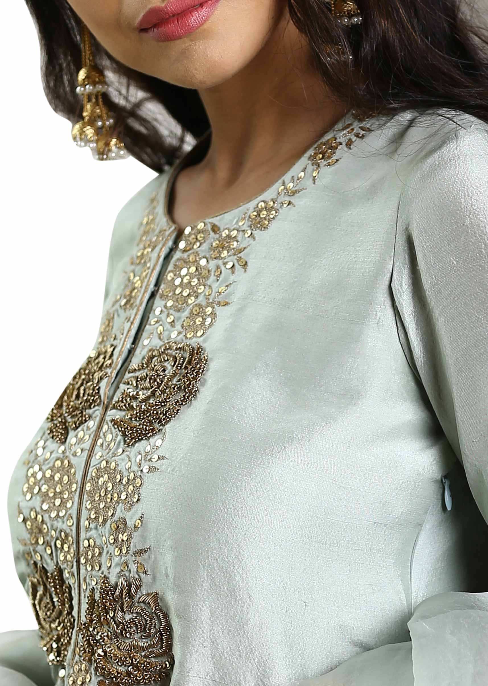 Sage green crepe embroidered suit paired with matching pants and organza dupatta