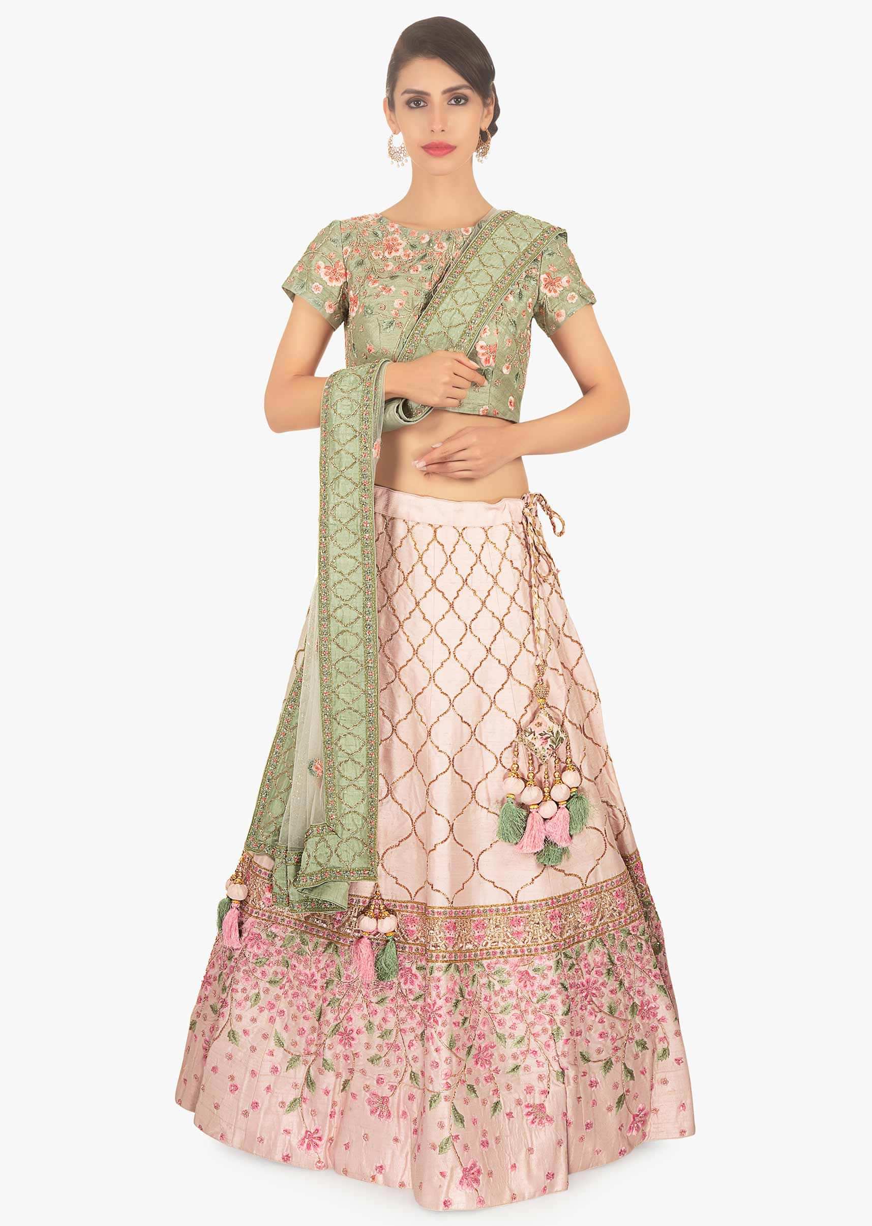 Sage green floral embroidered blouse paired with creamish pink lehenga and off white net dupatta