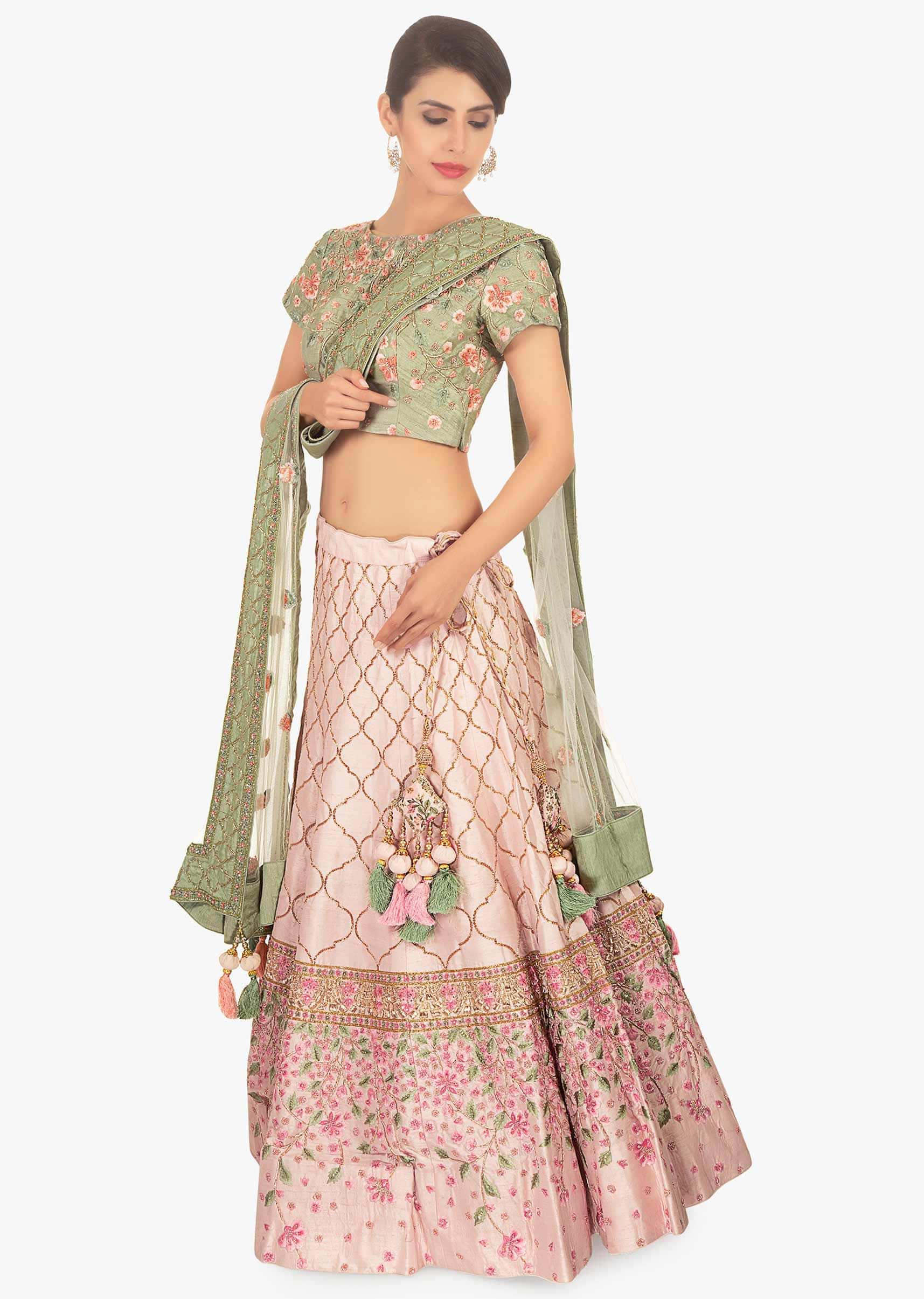 Sage green floral embroidered blouse paired with creamish pink lehenga and off white net dupatta