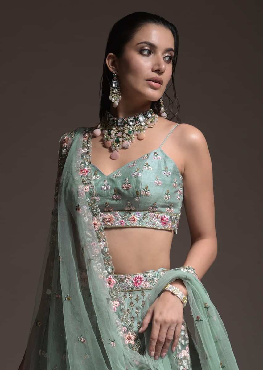 Sage Green Lehenga Choli In Raw Silk With Vibrant Resham Embroidered Cluster Of Summer Blooms And Buttis 