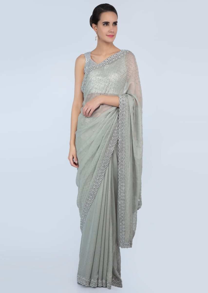 Sage green shimmer georgette saree adorn with moti scattered and heavy stone embroidered border only on Kalki