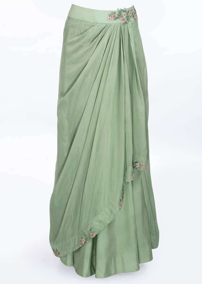 Sage green skirt with pleats paired with a floral embroidered blouse