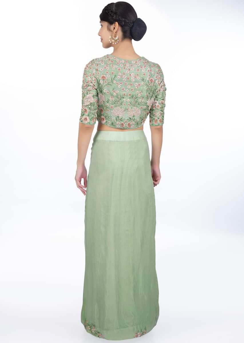 Sage green skirt with pleats paired with a floral embroidered blouse