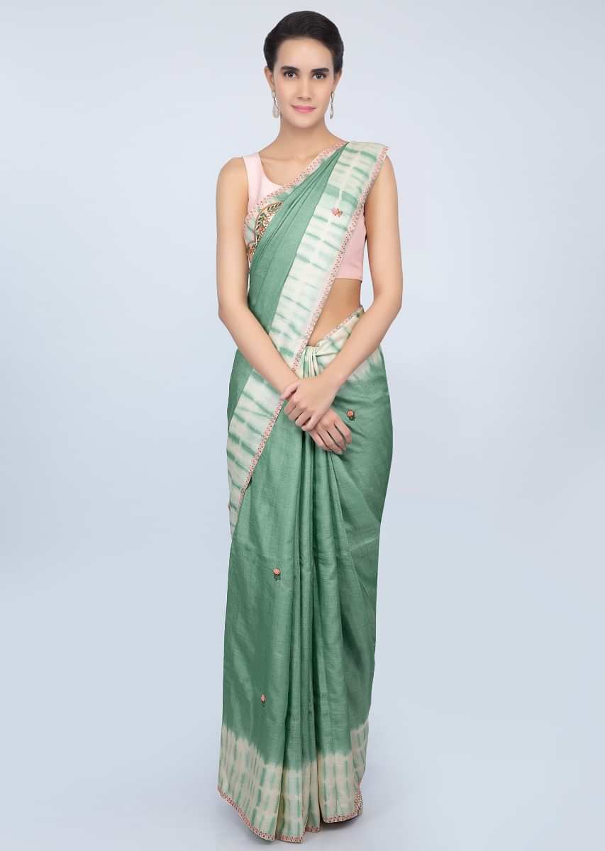 Sage green tussar silk saree with thread embroidered butti and batik print only on kalki