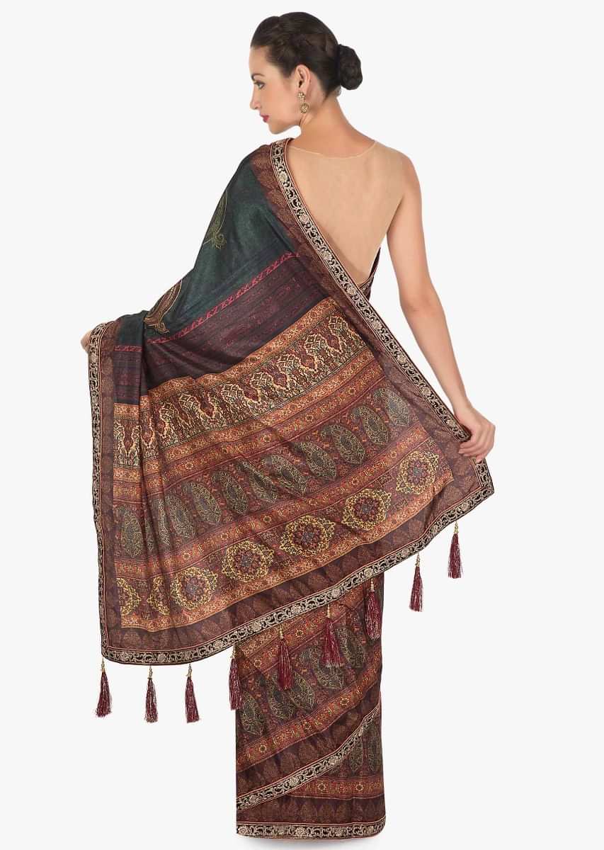 Saree in rust and brown shade with flroal print with fancy tassel only on Kalki