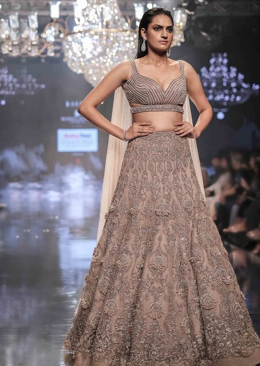 Shell Champagne Lehenga Hand Crafted In Heavy Embroidered Net In Floral Motifs 