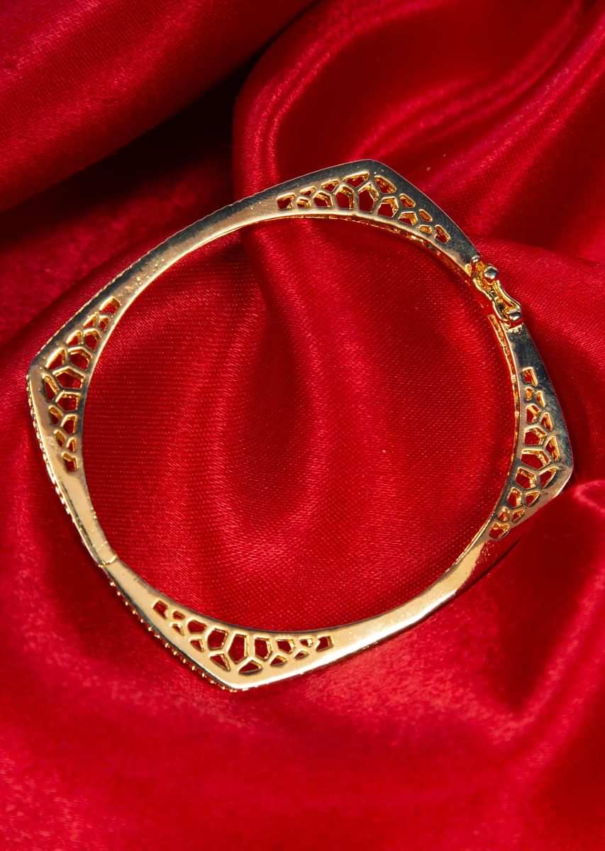 Shiny gold plated bracelet with stone studded edges only on Kalki