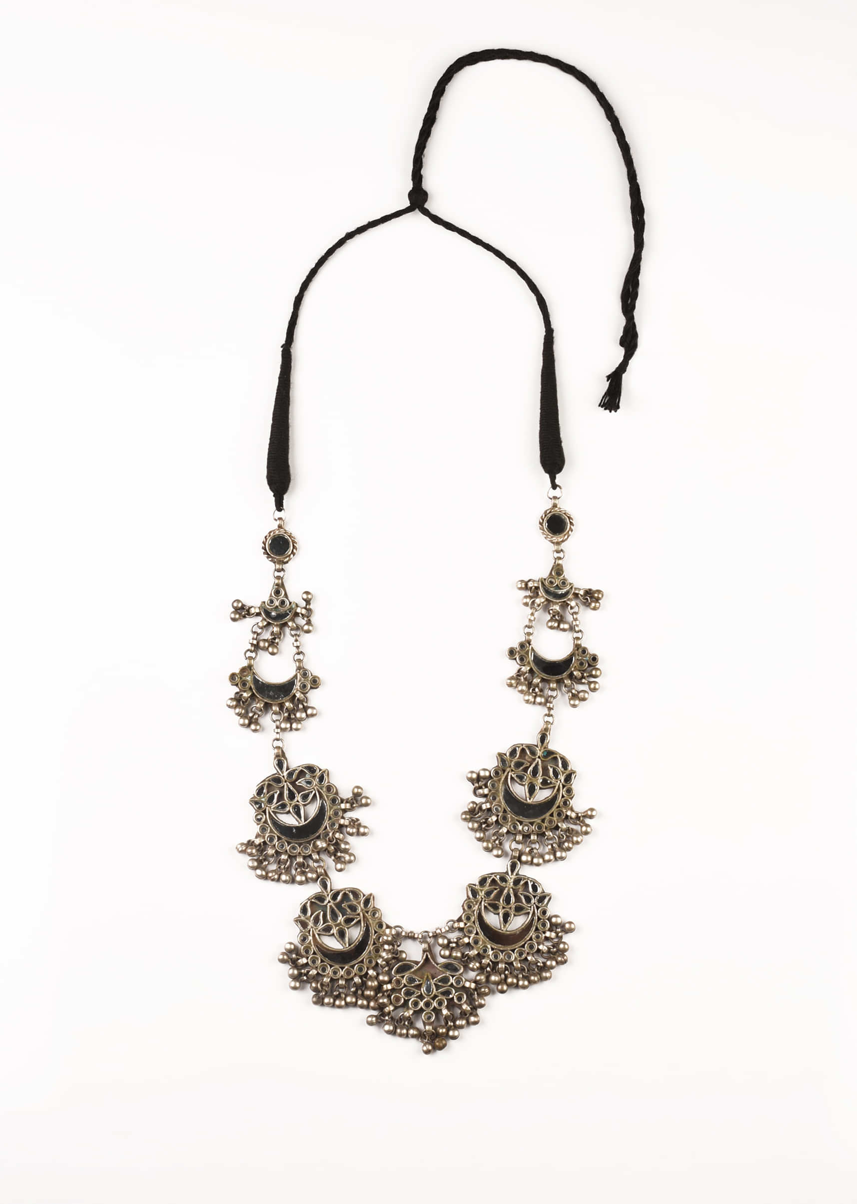 Silver Necklace With White Mirror Embellished Crescent Ethnic Motifs And Bunches Of Ghungroo Tassels 