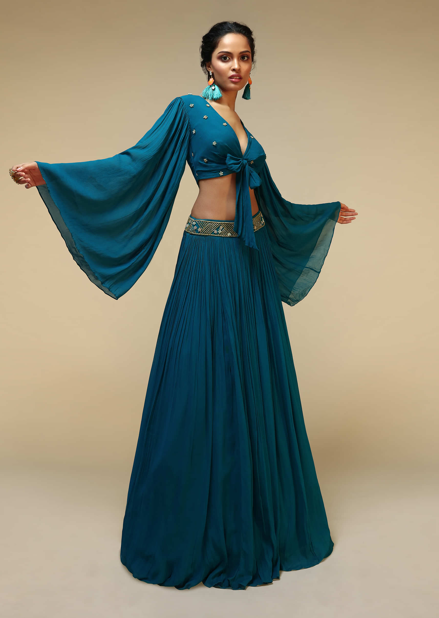 Teal Blue Skirt And Bell Sleeves Crop Top With Front Bow Tie Up Design And Multi Colored Sequin Embroidered Buttis 
