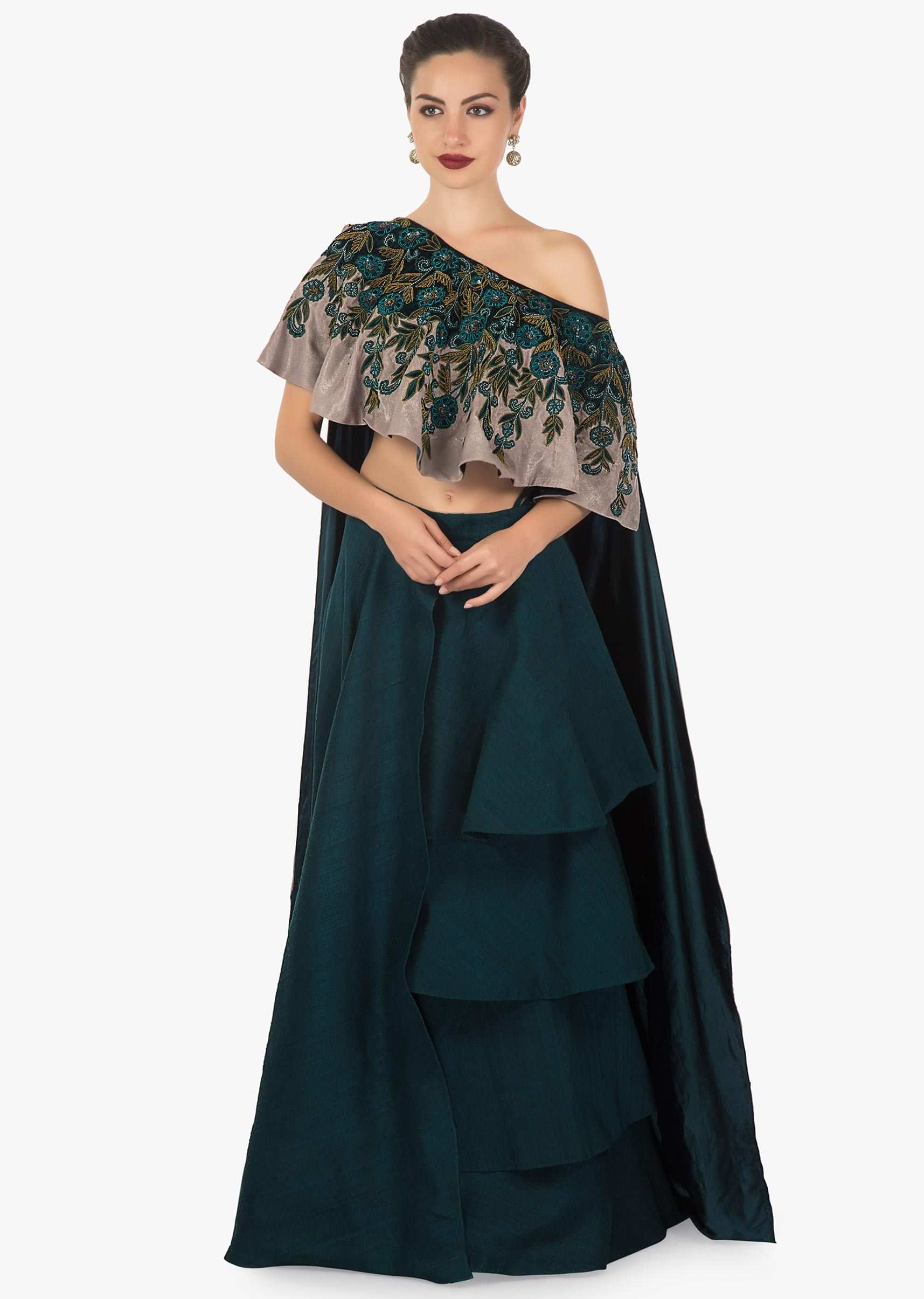 Teal green layered skirt matched with fancy cape blouse in velvet applique work
