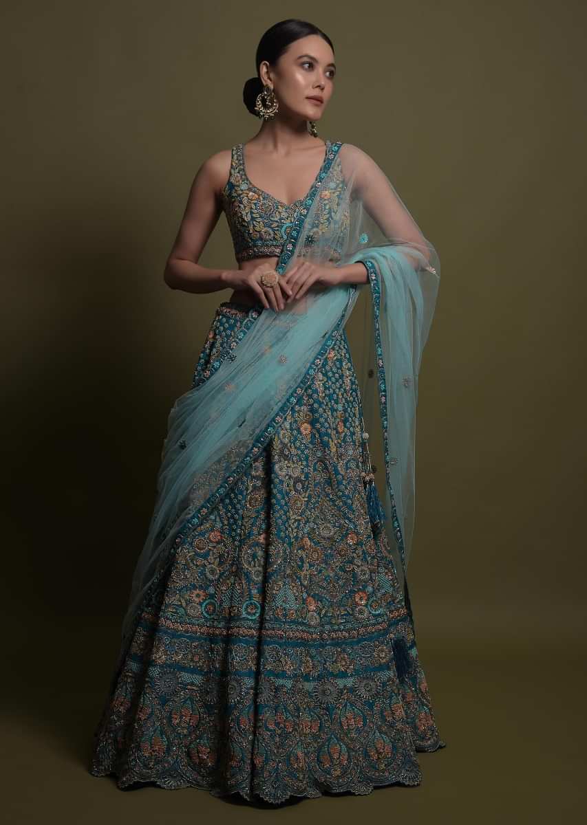 Teal Lehenga Choli In Raw Silk Hand Crafted With Embossed Embroidery In Heritage Floral Pattern 