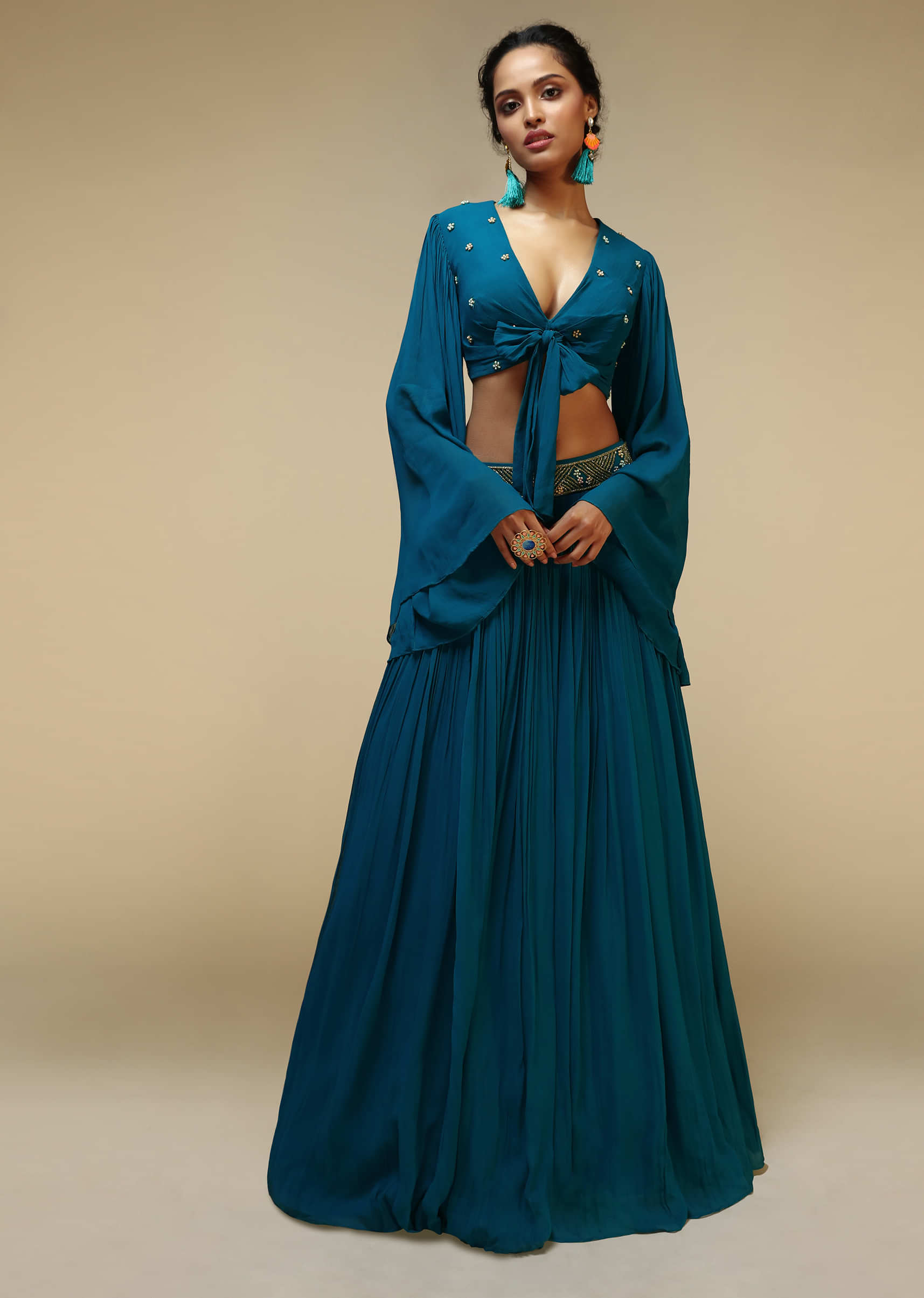 Teal Blue Skirt And Bell Sleeves Crop Top With Front Bow Tie Up Design And Multi Colored Sequin Embroidered Buttis 