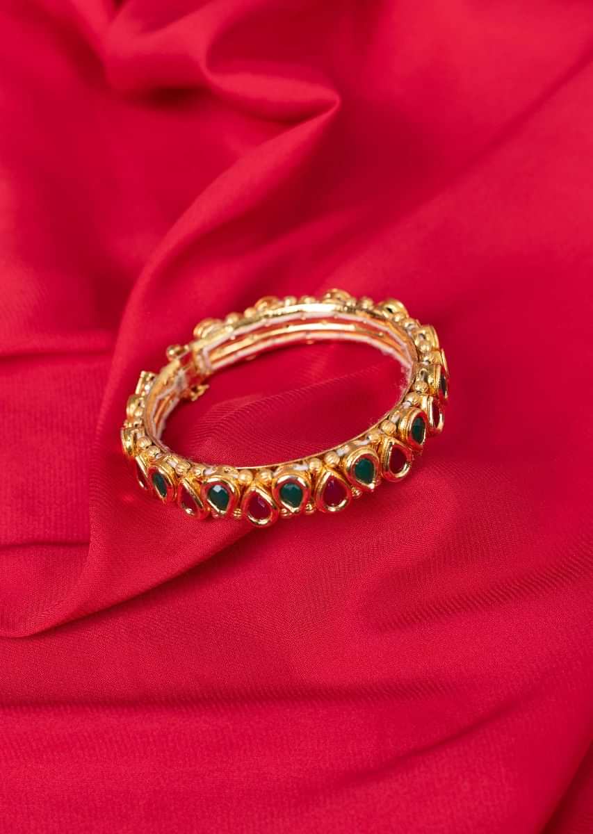 Traditional gold plated kada in magenta and emerald green beads only on Kalki