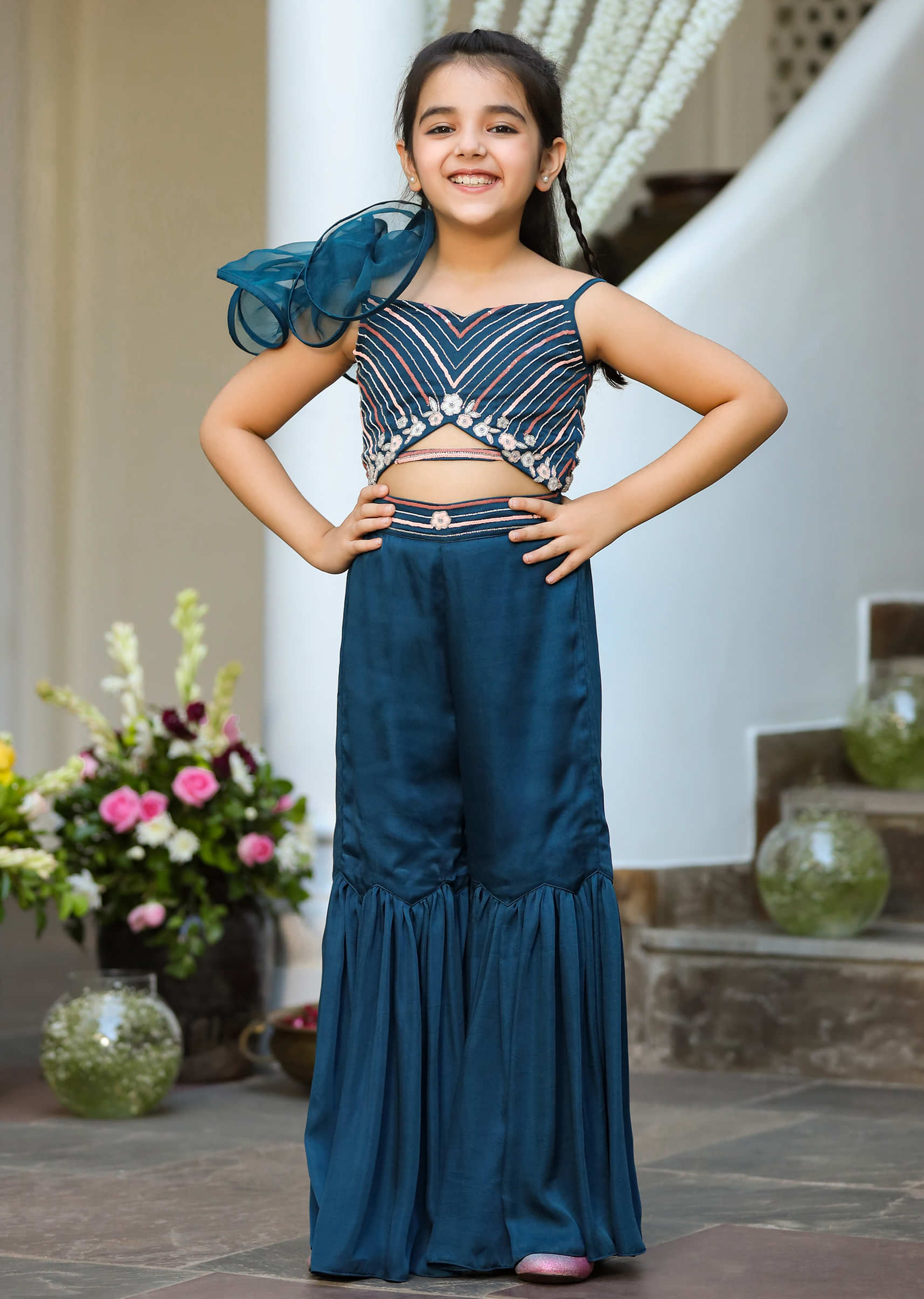 Kalki Girls Turquoise Blue Sharara Jumpsuit With A Front Cut Out And Ruffled Organza Flower On The Shoulder