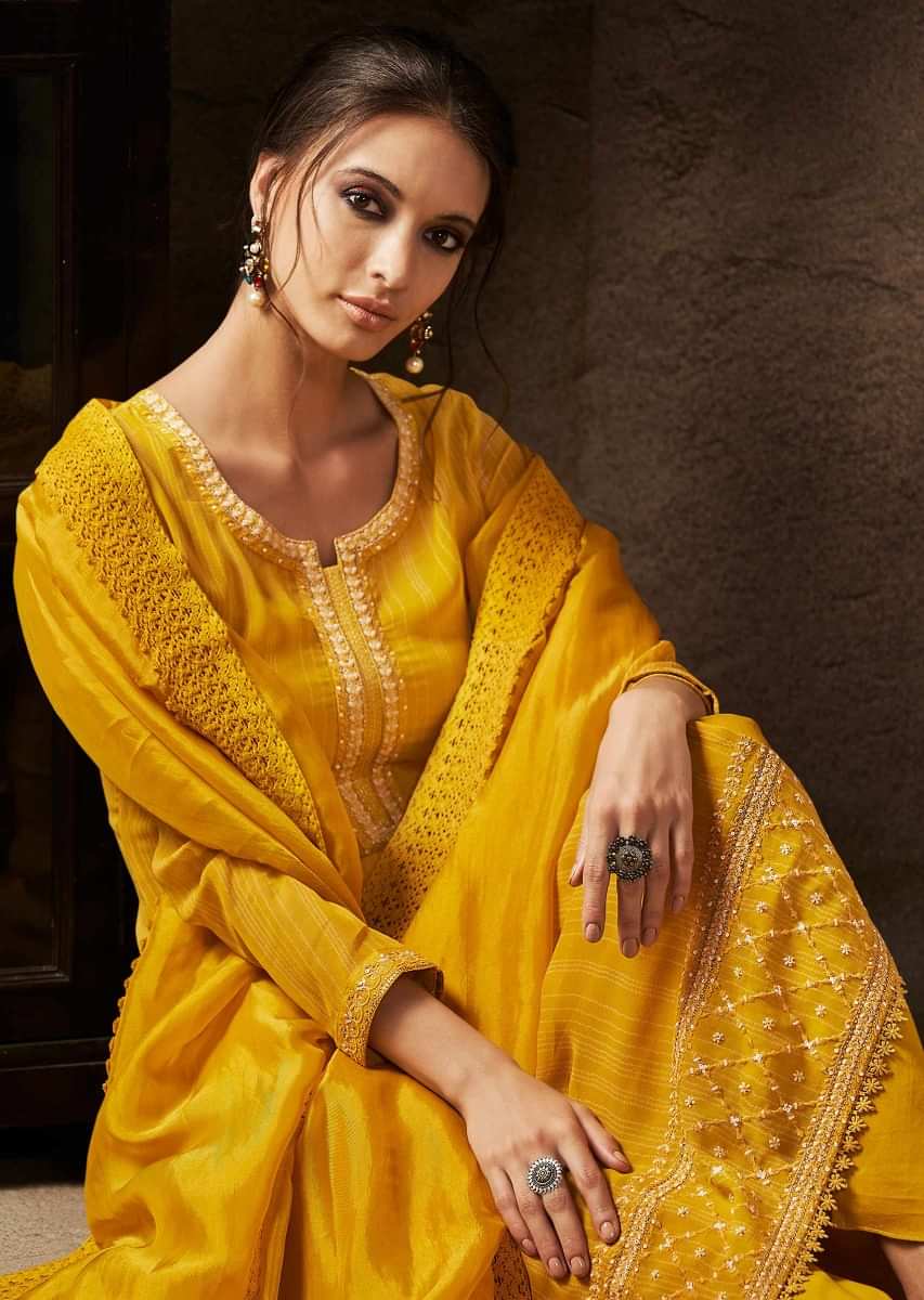 Unstitched suit chrome yellow in resham embroidered placket and hem line