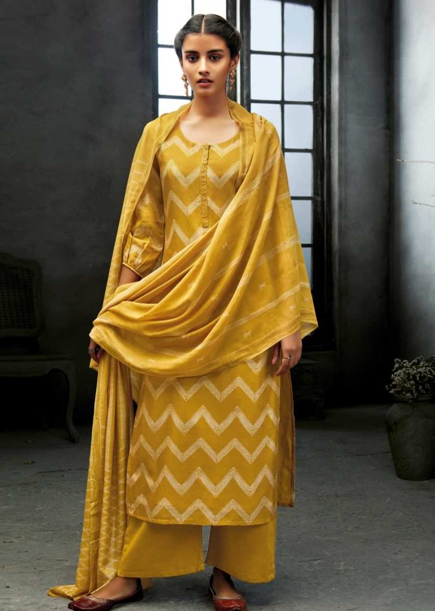 Unstitched suit featuring in canary yellow with chevron printed pattern and sequin work