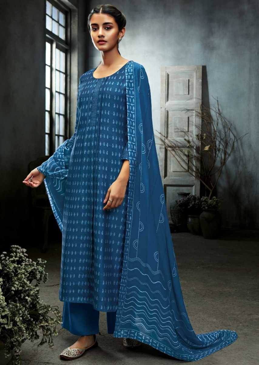 Unstitched suit featuring in cotton silk with printed butti and lace border