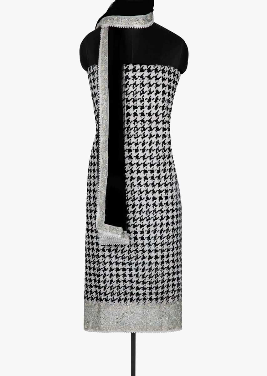 Unstitched suit in black and white embellished in zari cut work only on Kalki