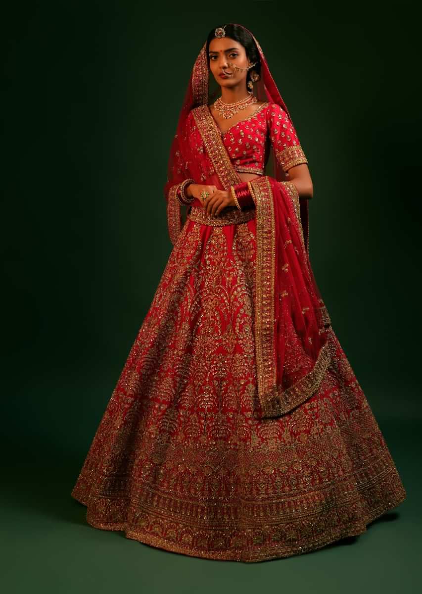 Vermillion Red Lehenga Choli In Raw Silk With Heavy Embroidered Kalis In Ethnic Motifs Adorned In Colorful Resham And Cut Dana Work 