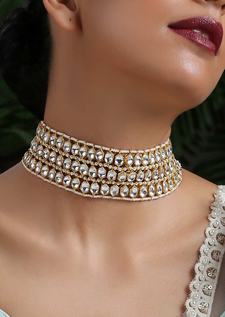 White And Gold Necklace With Four Rows Of Pearls Arranged In Symmetry Between Hexagon Shaped Kundan