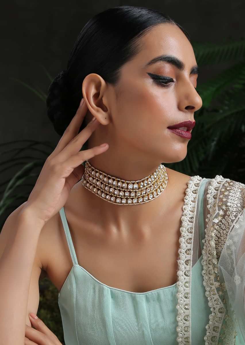 White And Gold Necklace With Four Rows Of Pearls Arranged In Symmetry Between Hexagon Shaped Kundan