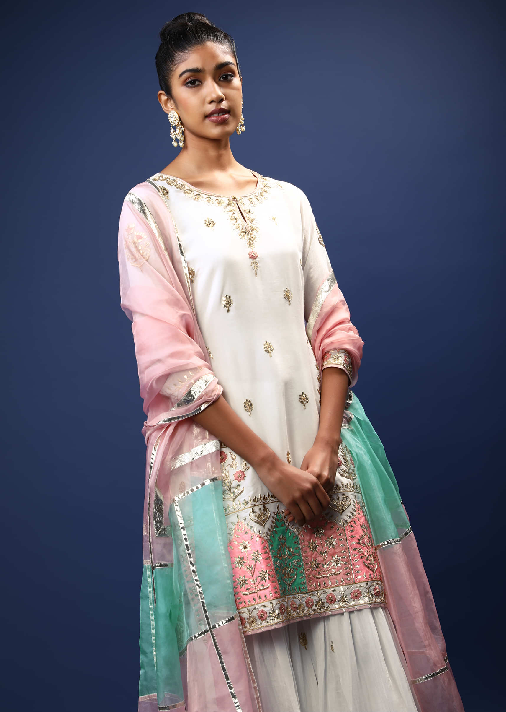 White Sharara Suit In Cotton With Gotta Patti Embroidered Buttis And A Multicolored Applique Work On The Border  