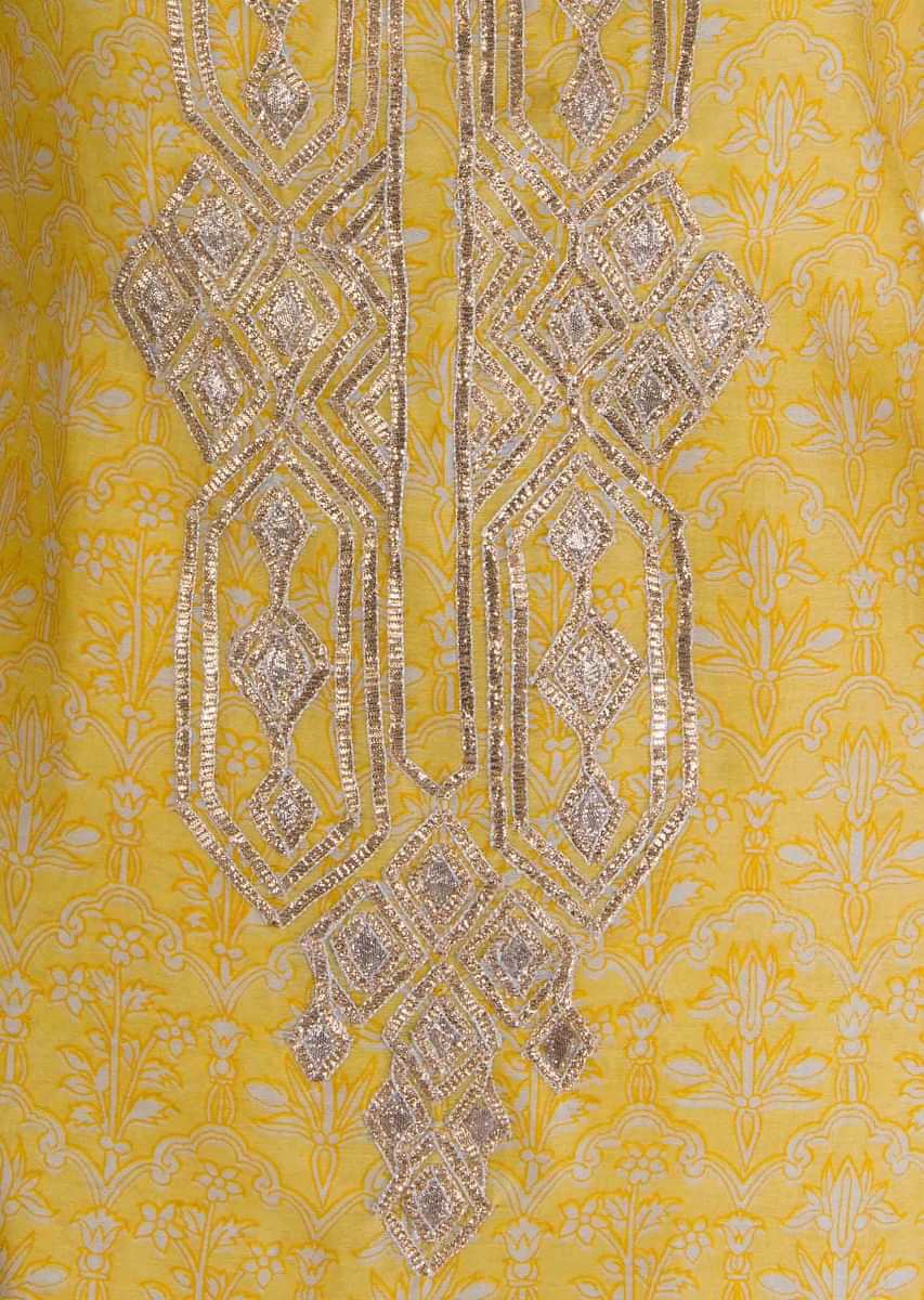 Yellow unstitched silk suit in print with gotta lace embroidered neckline and placket 