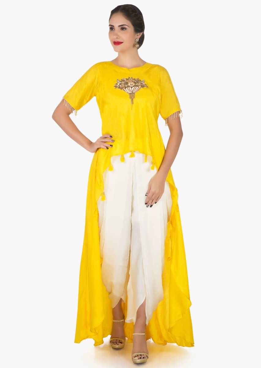 Yellow and white dhoti suit with a over layer embellished in resham and sequin butti work only on Kalki