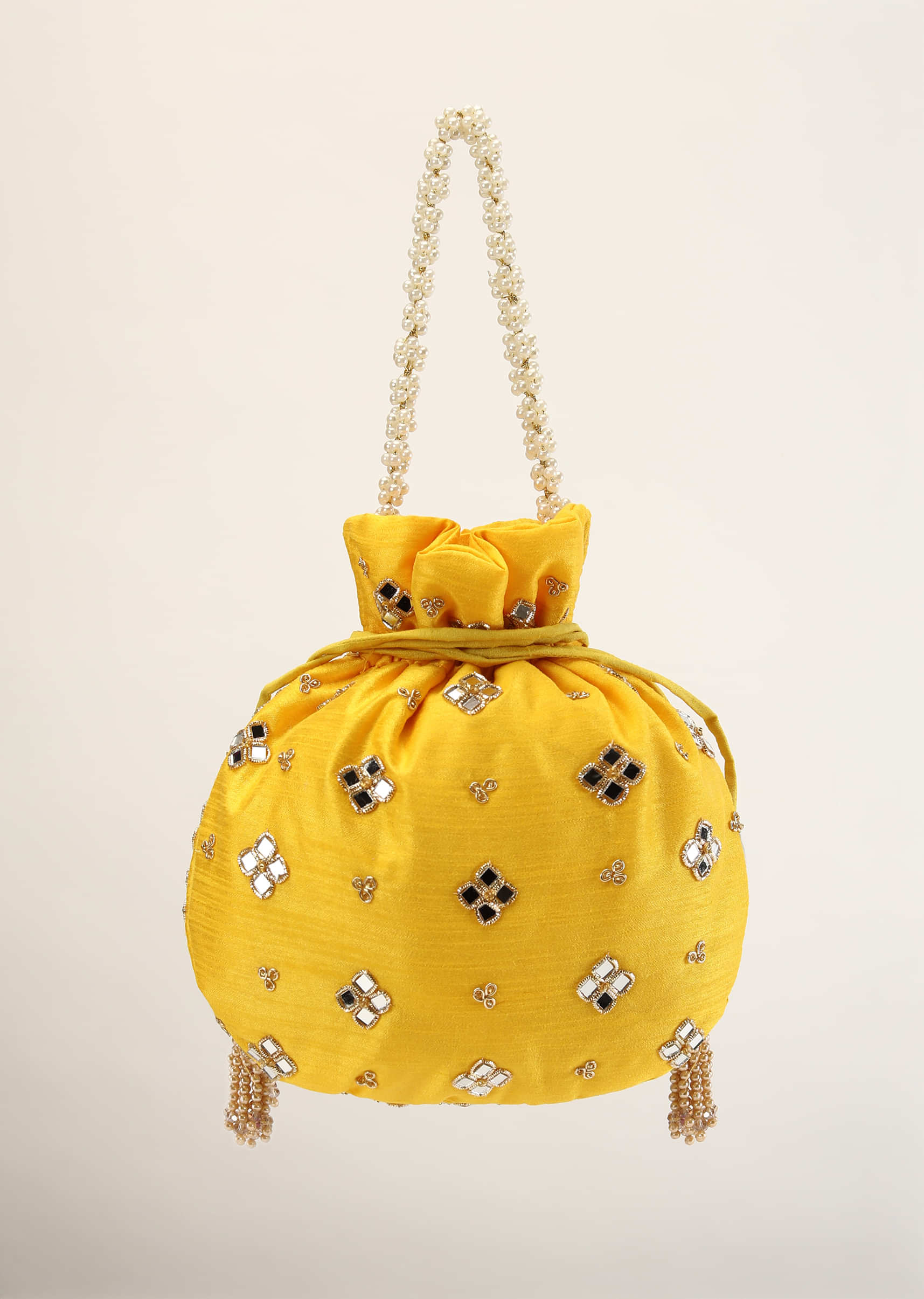 Yellow Potli In Satin With Hand Embroidery Detailing Using Mirror And Zardosi In Geometric Design
