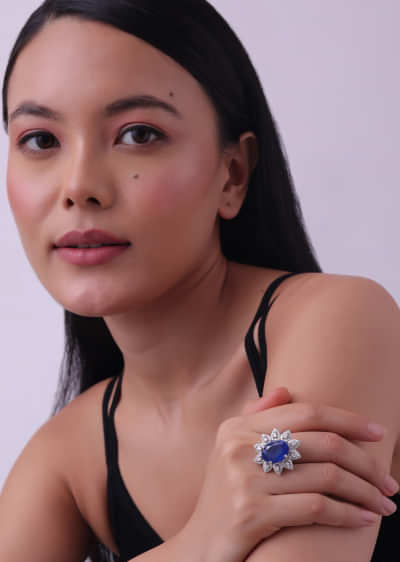 92.5 Sterling Silver Flower Shaped Ring Studded With Oval-Shaped Sapphire Blue Stone